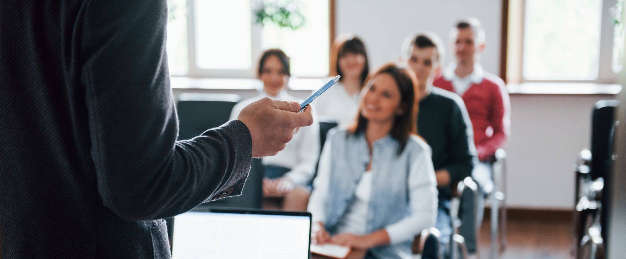 Persone che ascoltano un'altra persona che tiene una lezione.